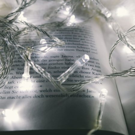 white string lights turned on on opened book