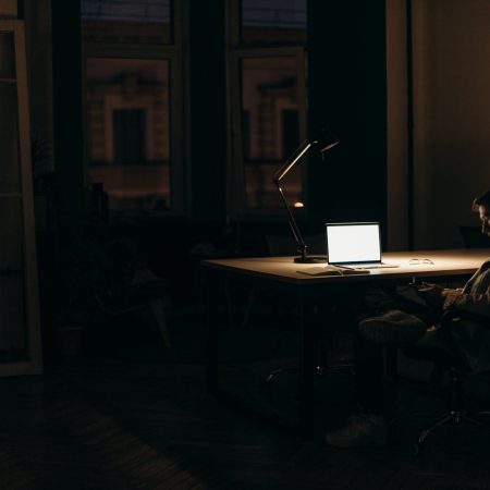 silver macbook on brown wooden table